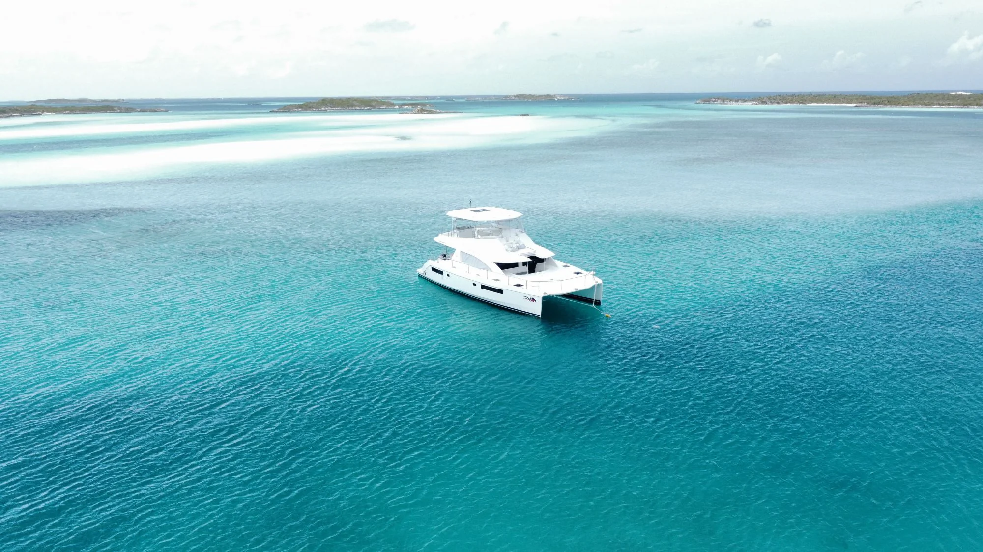 A white yacht in a wide expanse of turquoise sea, illustrating the Private Yacht Marine studio concept